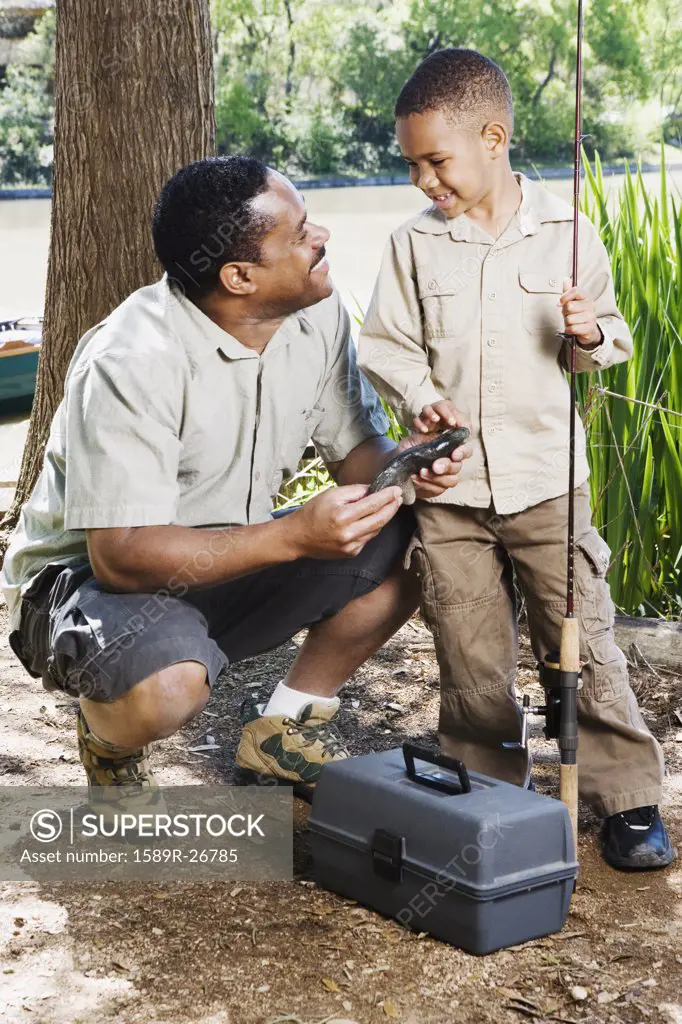 African father and son with fishing gear