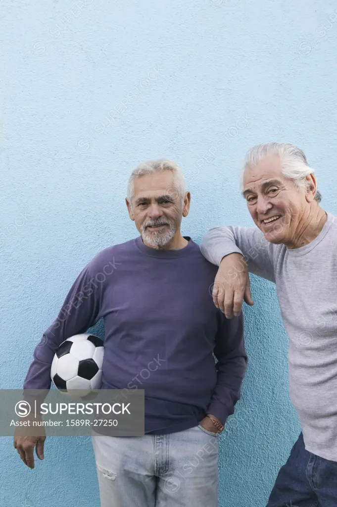 Two senior men with soccer ball