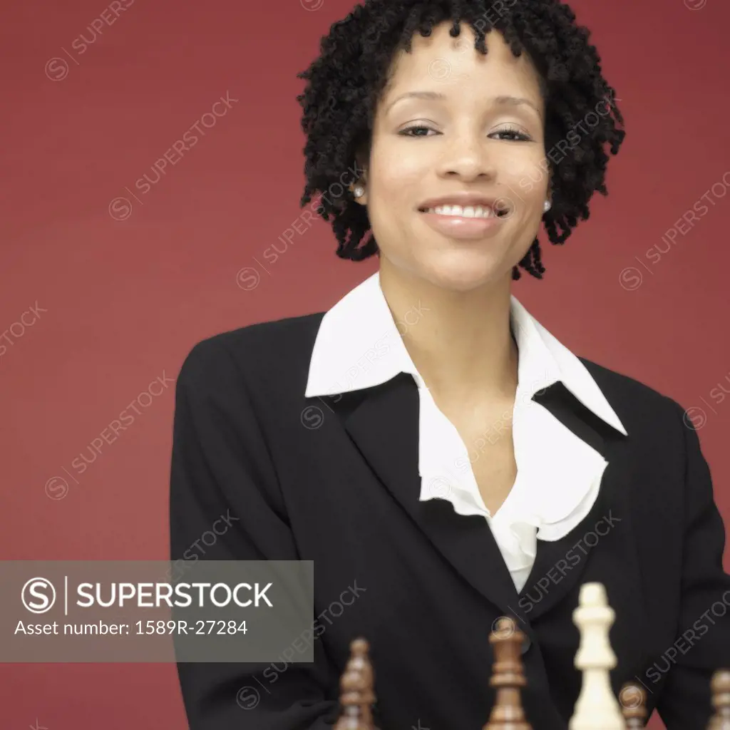 Studio shot of African woman playing chess