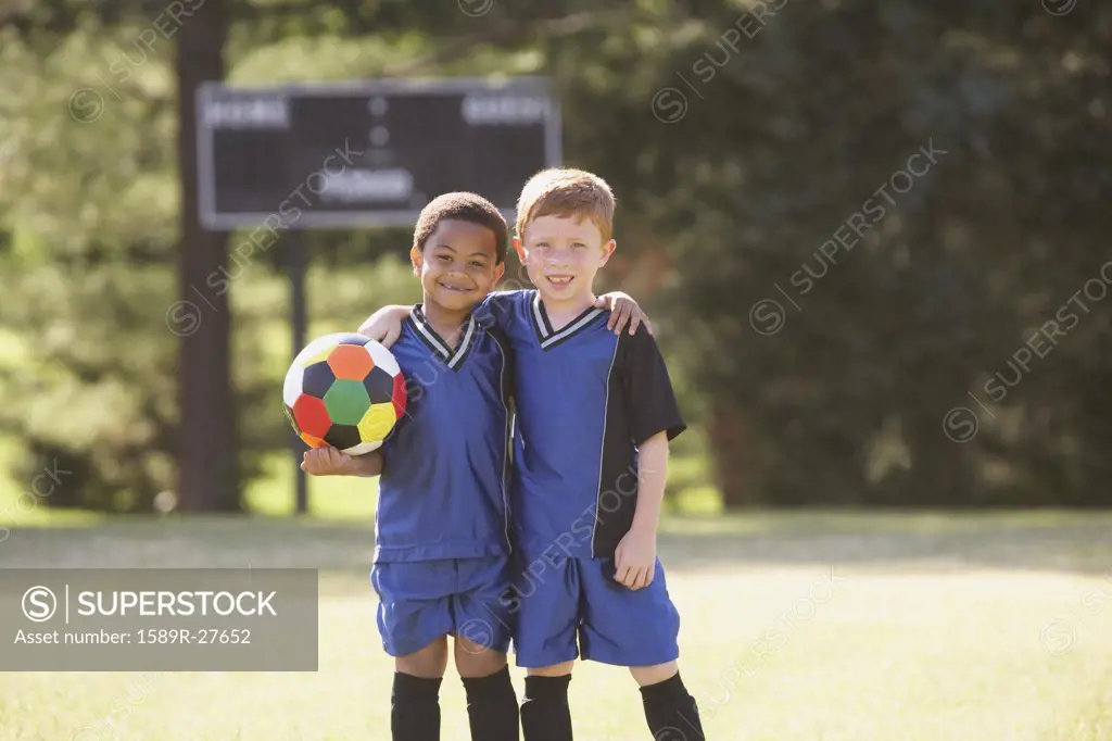 Two young boys in soccer gear with ball