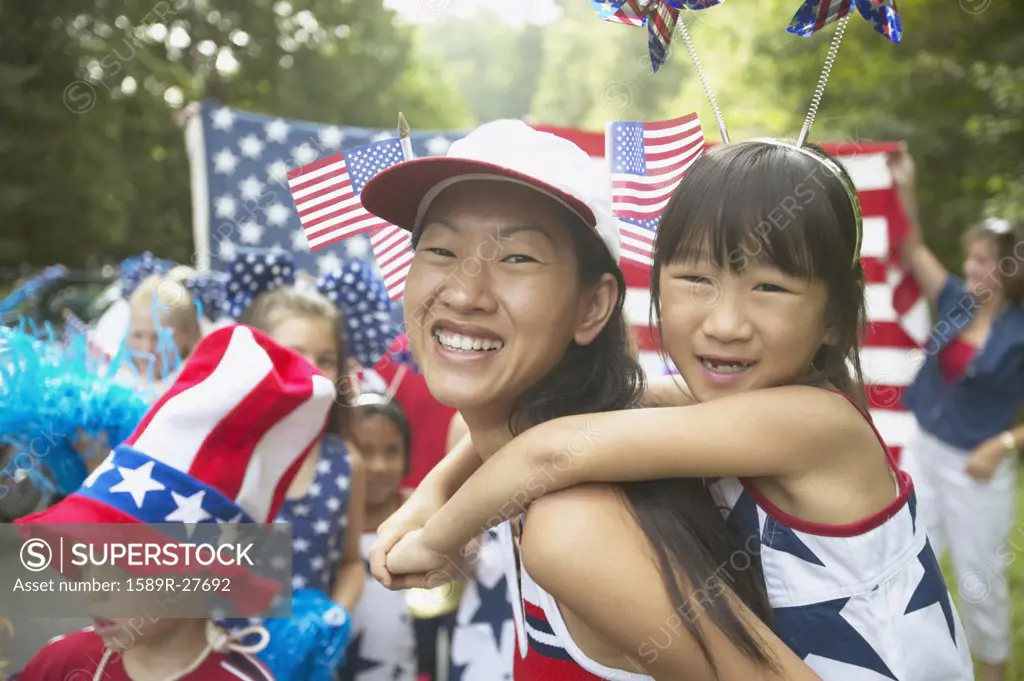 Asian mother and daughter in Fourth of July parade