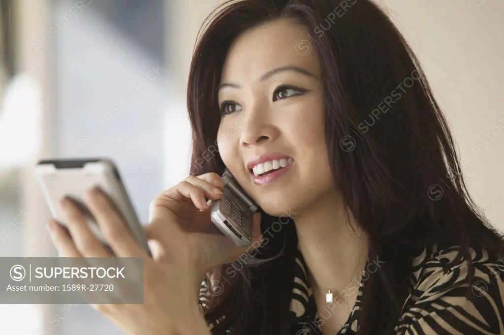 Young Asian woman using cell phone