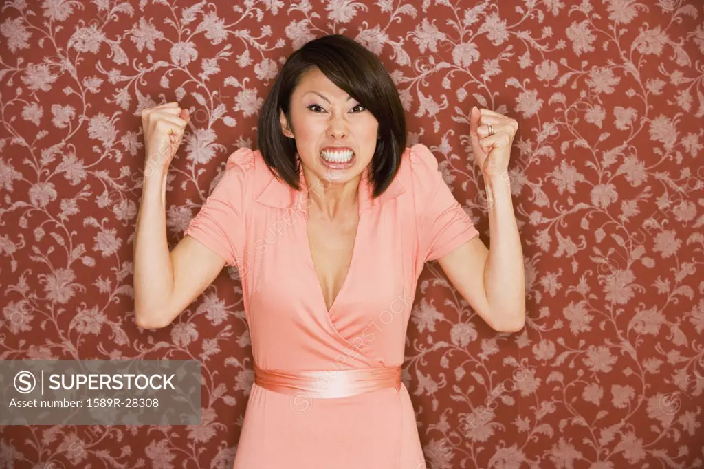 Angry Asian woman with hands in fists