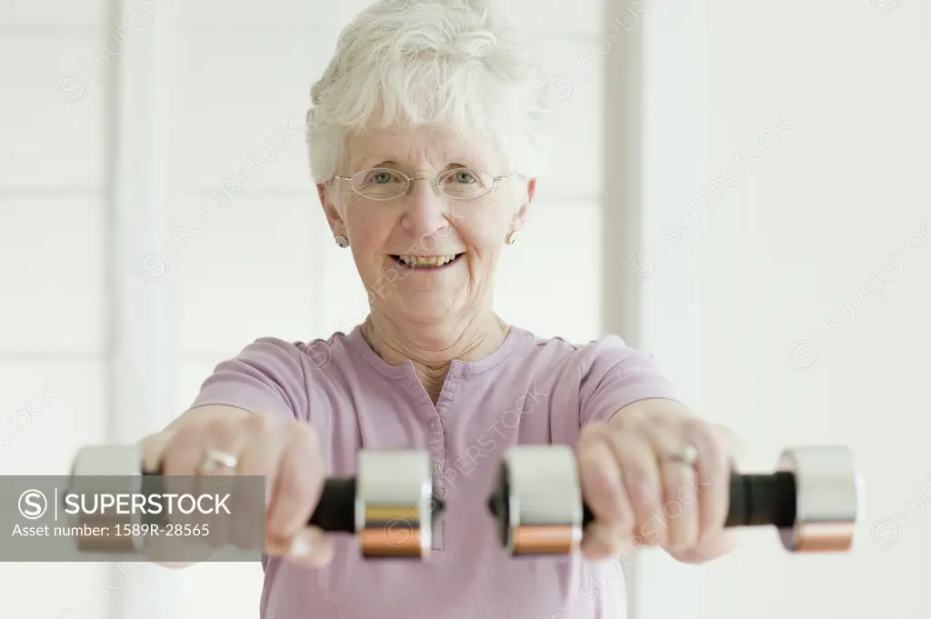 Senior woman lifting free weights