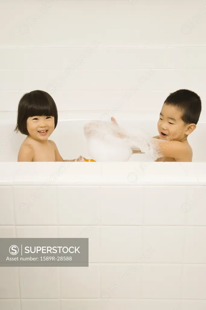 Young Asian sister and brother in bathtub