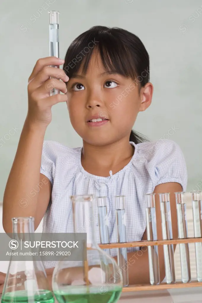 Young Asian girl with science equipment