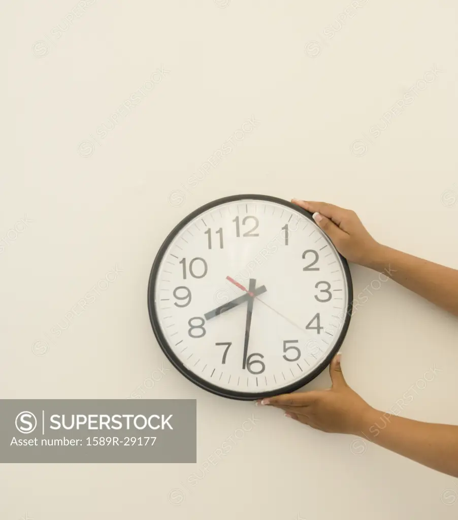 Girl's hand's holding clock