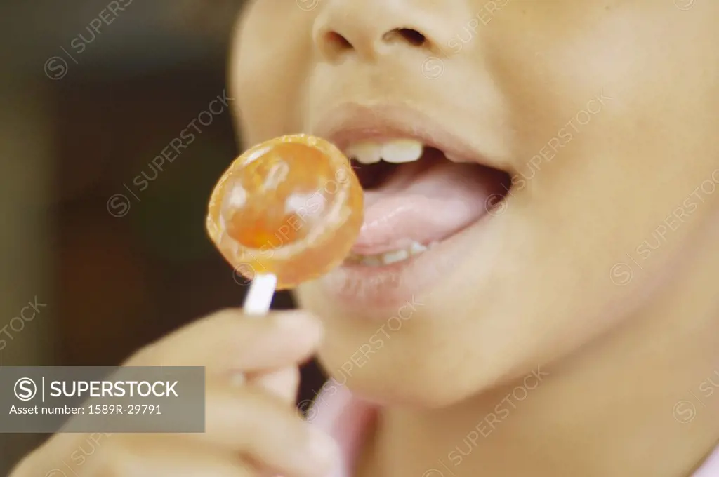 Close up of African boy about to lick a lollypop