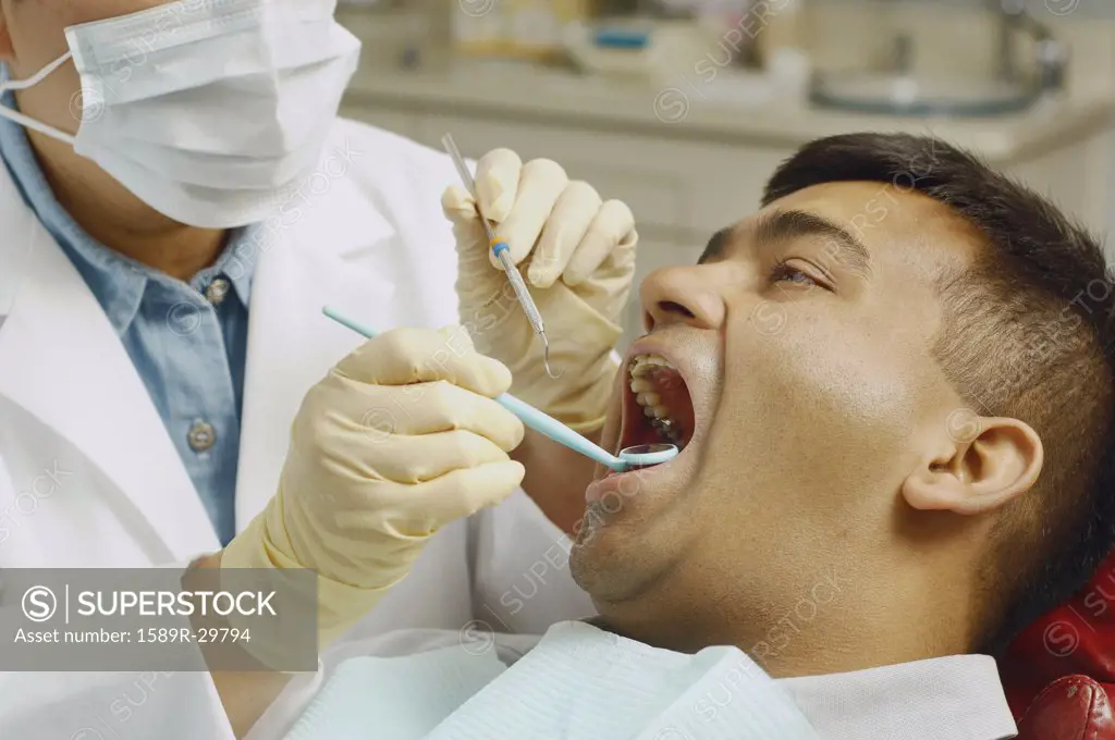 Dentist working on Indian man