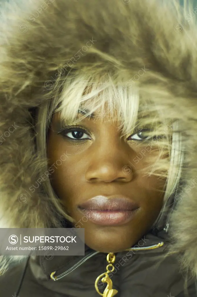 Close up of African woman wearing coat with fur hood