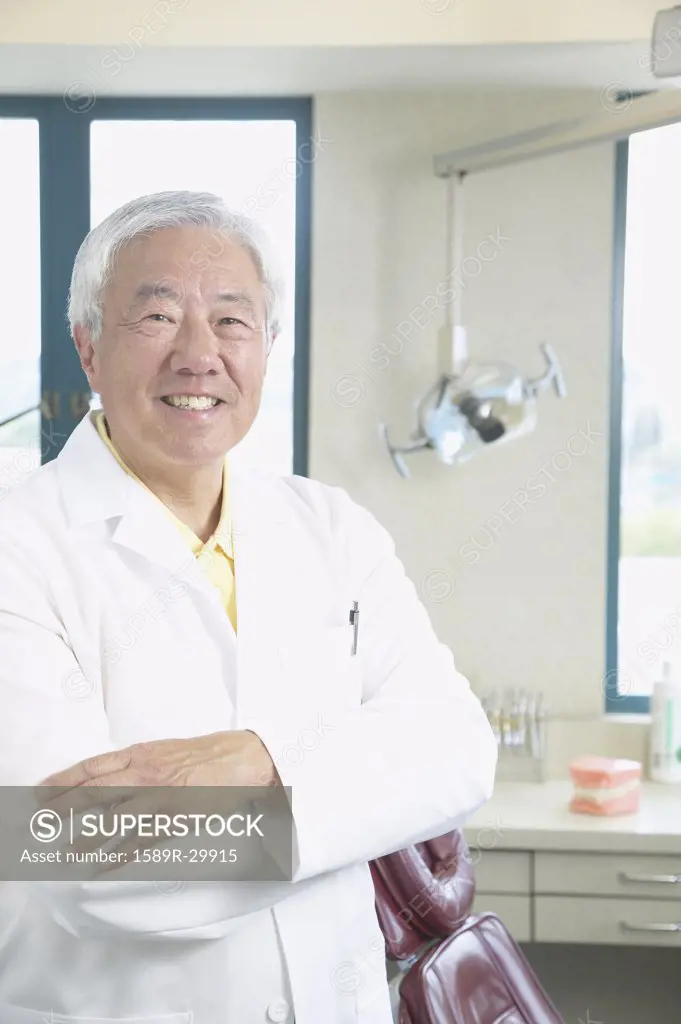 Senior Asian male dentist smiling