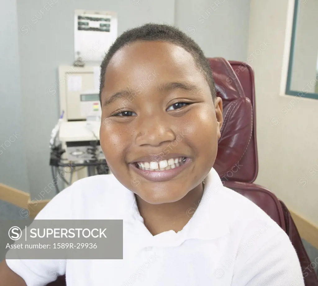 African boy smiling in dentist's chair