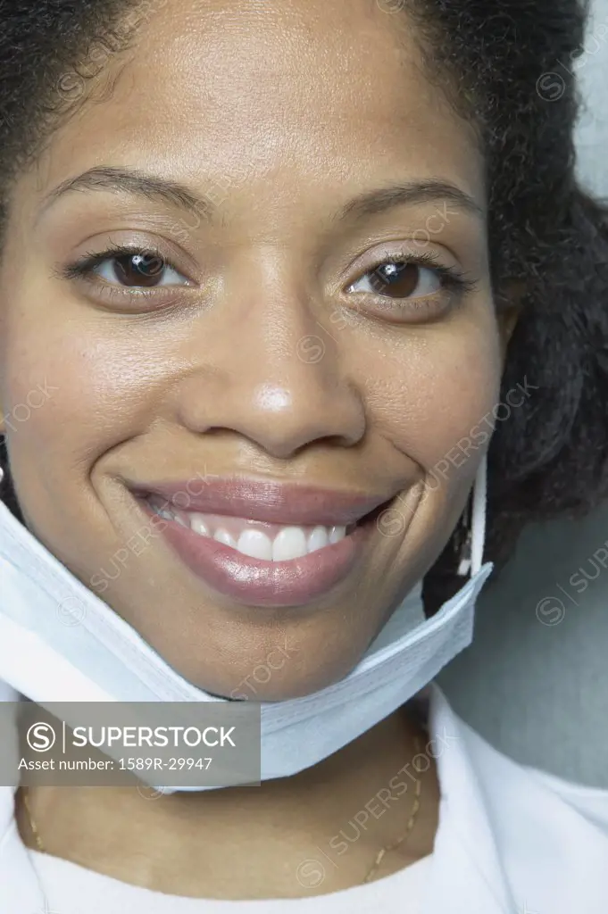 Close up of African woman smiling with surgical mask