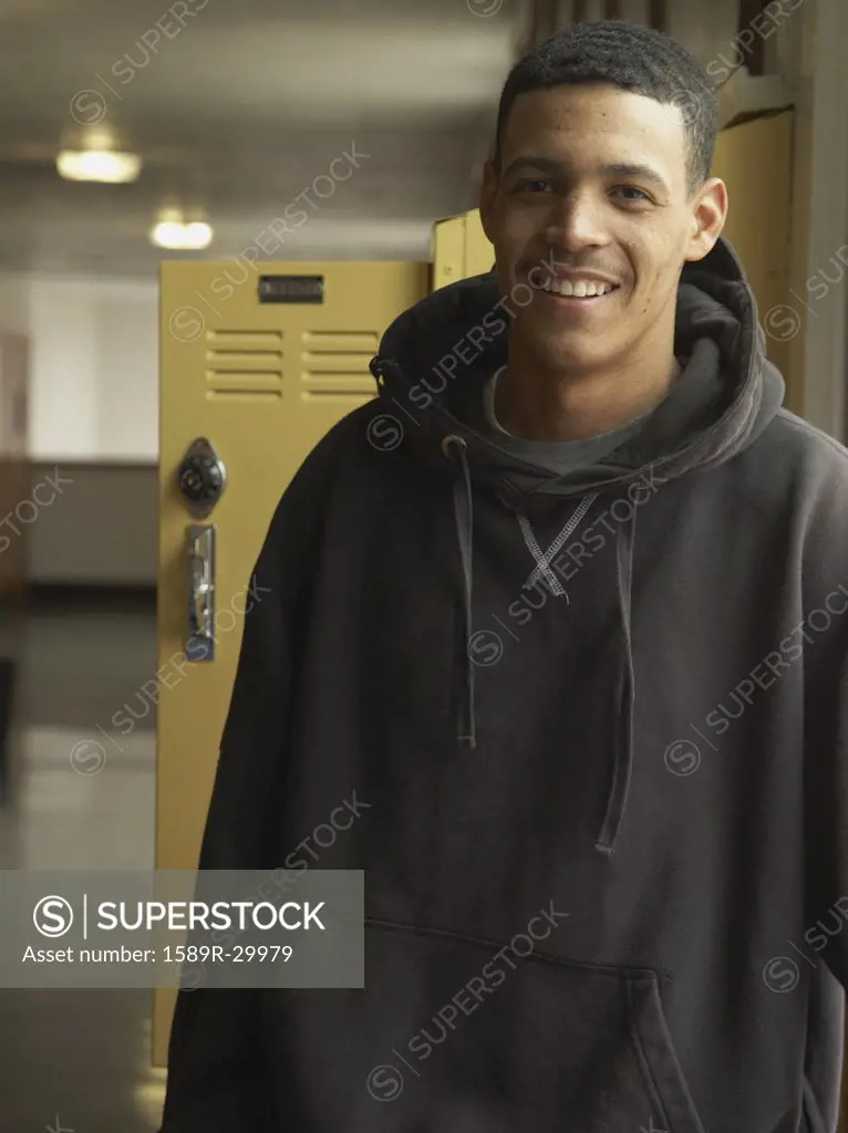 Young African man next to school lockers