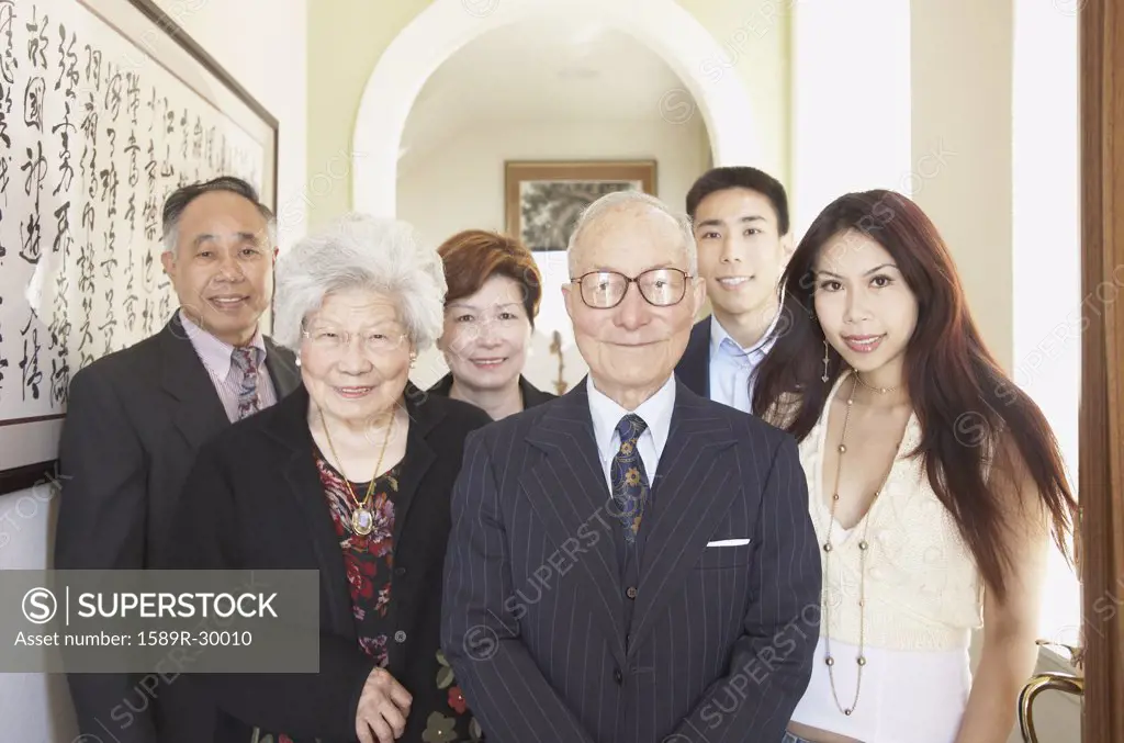 Multi-generational Asian family smiling indoors