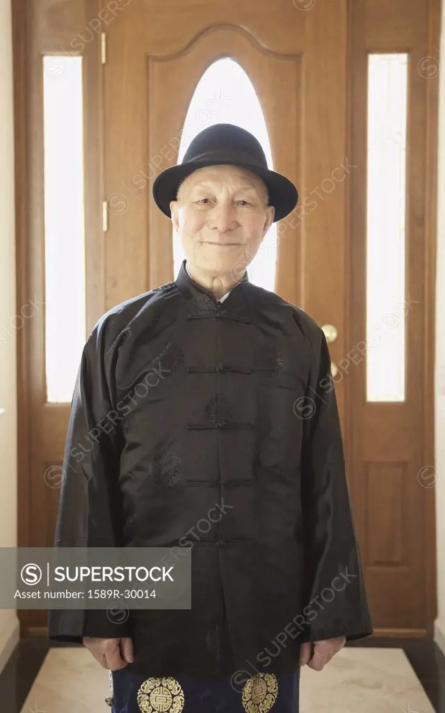 Senior Asian man smiling in traditional dress