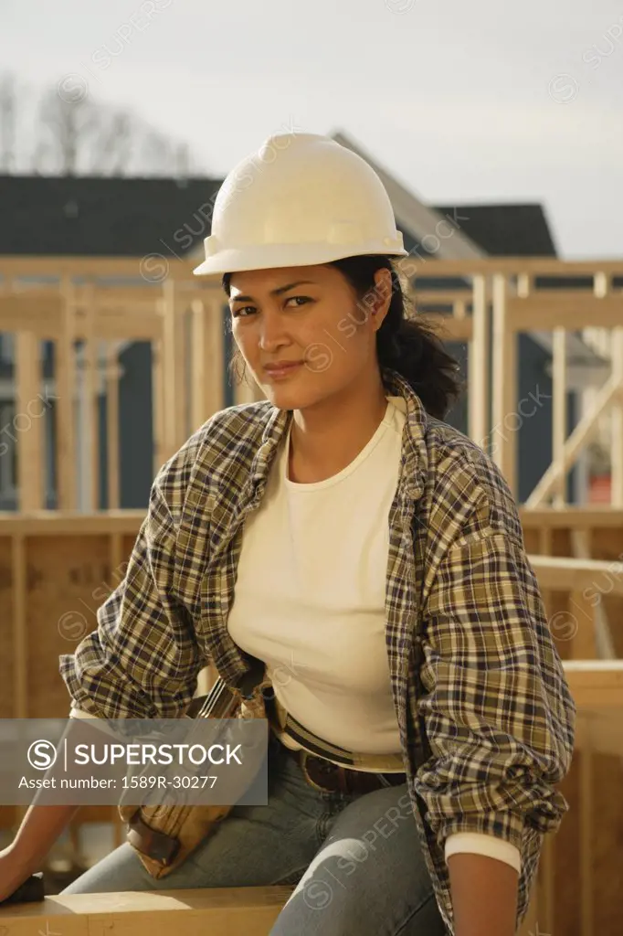 Asian female construction worker at construction site