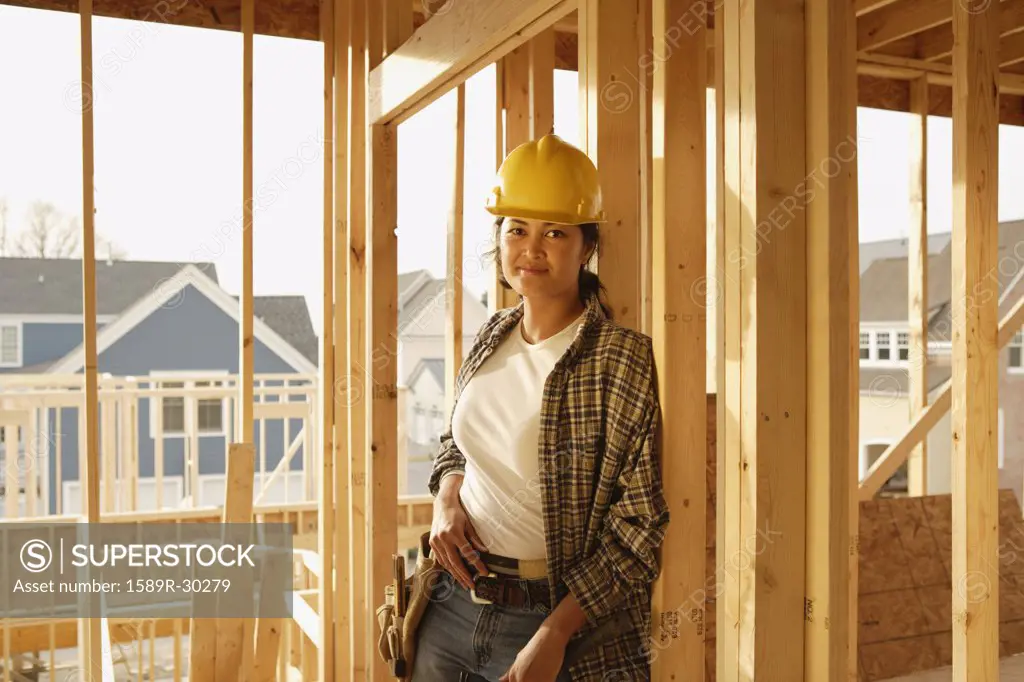 Asian female construction worker inside construction site