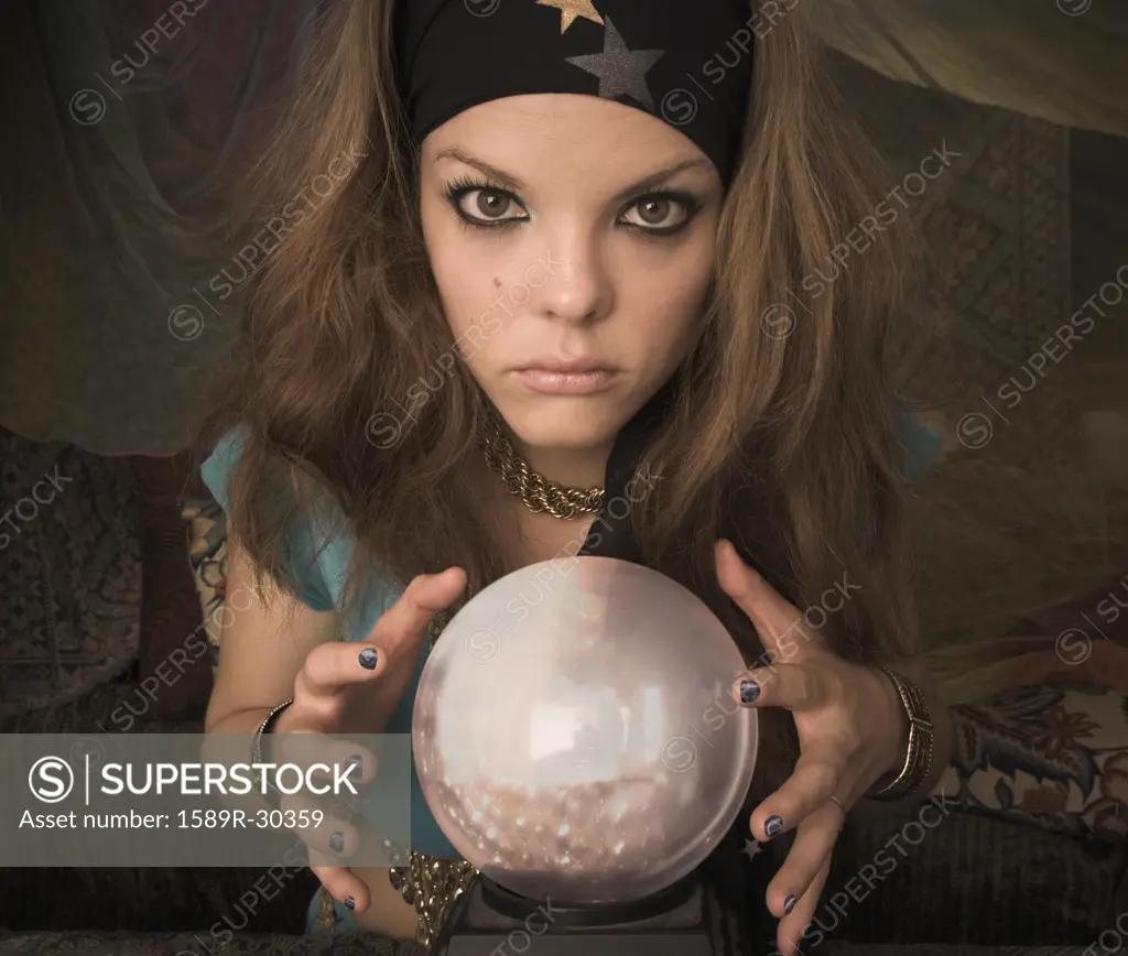 Woman dressed at fortune teller with crystal ball