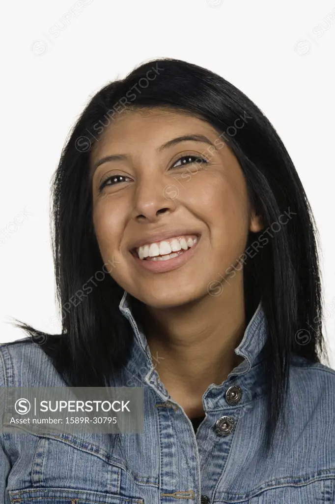 Close up studio shot of Hispanic woman smiling