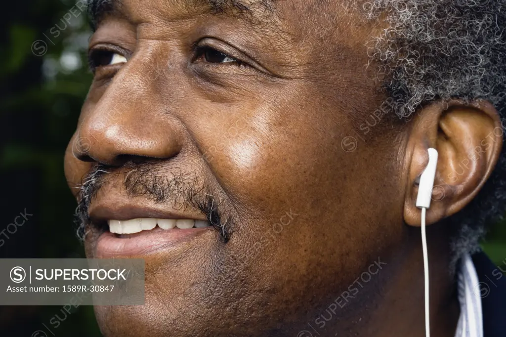 Close up of senior African man with earbud
