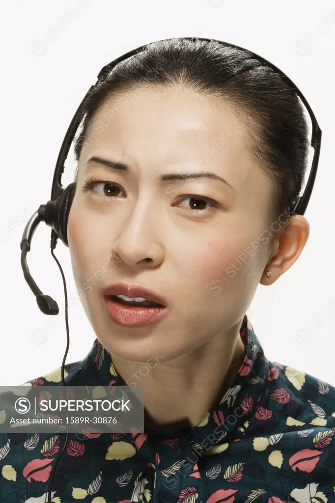 Studio shot of Asian woman wearing headset
