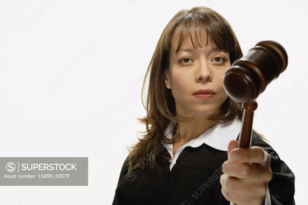 Studio shot of Hispanic female judge holding gavel