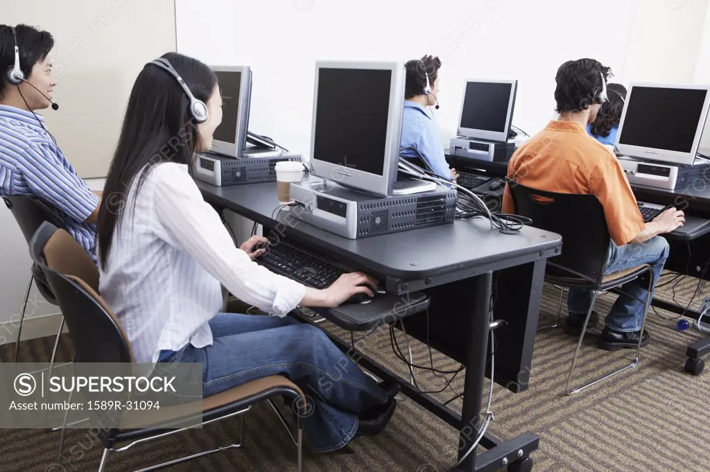 Young computer service technicians with headsets 