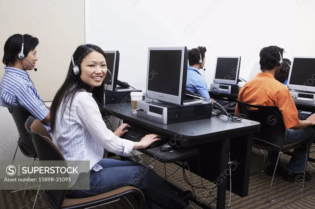 Young computer service technicians with headsets 