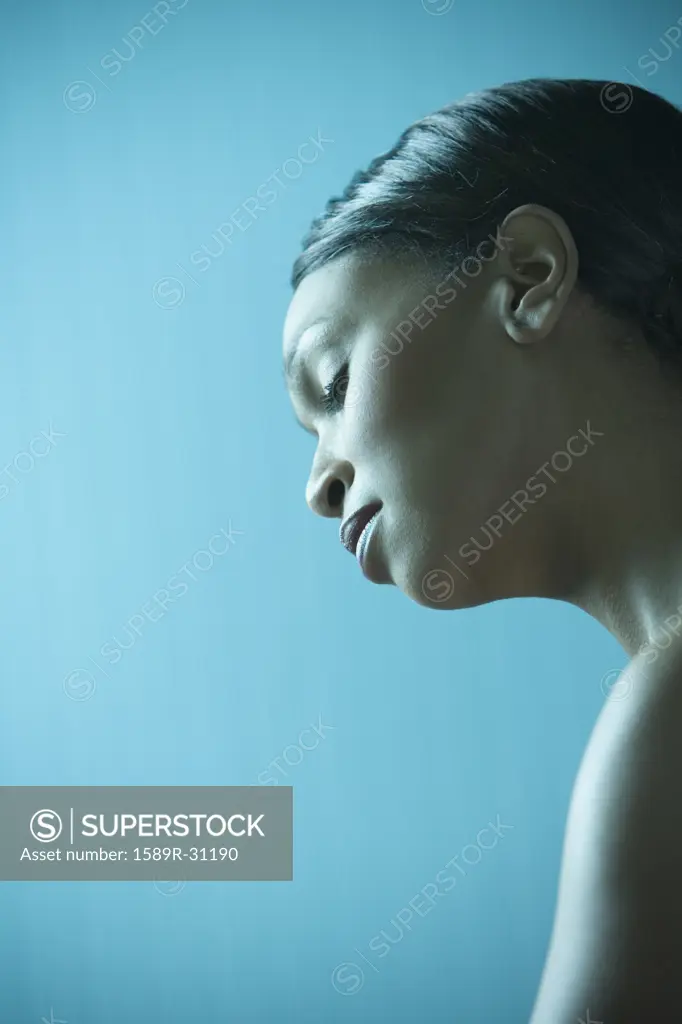 African woman with bare shoulders and eyes closed