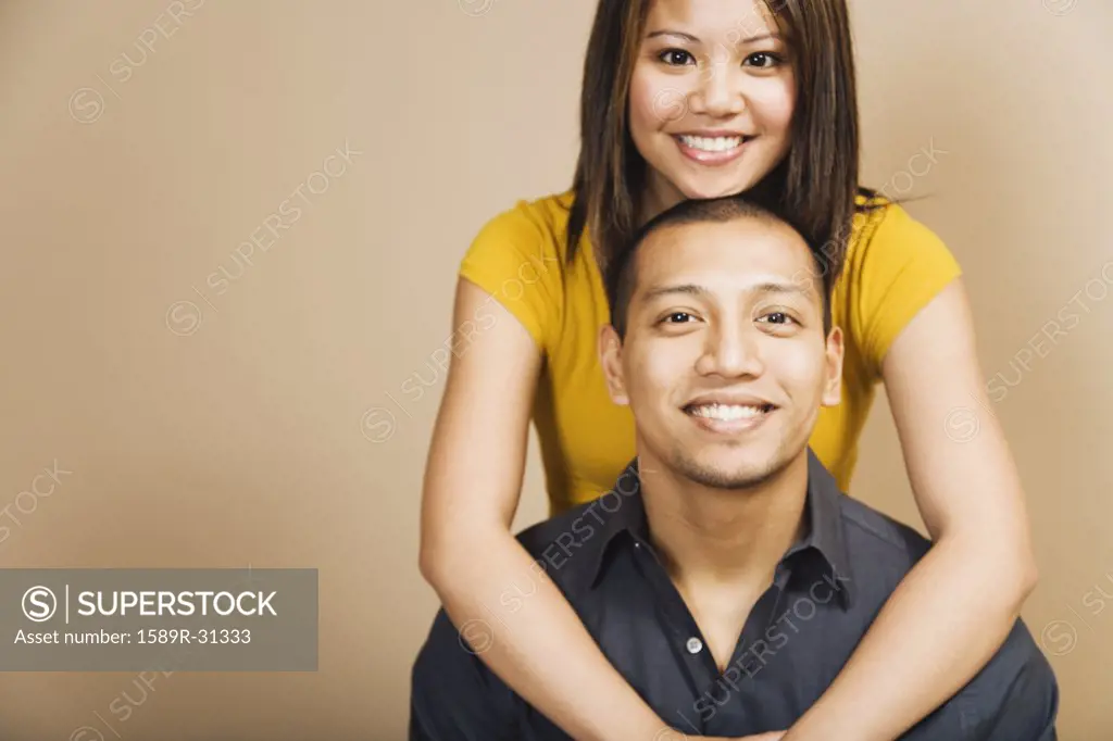 Studio shot of Asian couple smiling