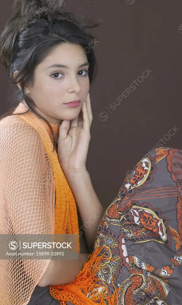 Hispanic girl with hand on face