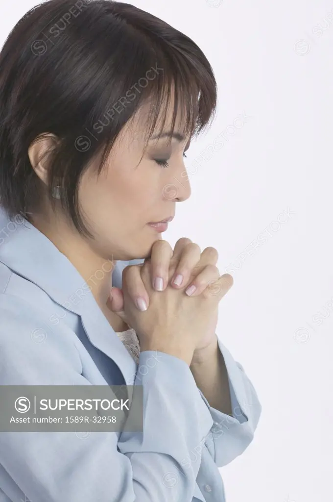 Asian businesswoman praying
