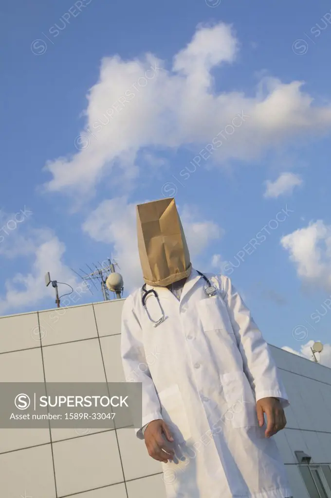 Male doctor wearing bag over head