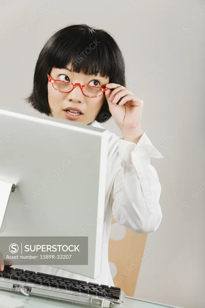 Portrait of Asian woman sitting at computer
