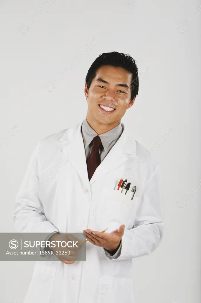 Portrait of Asian male scientist holding pencil