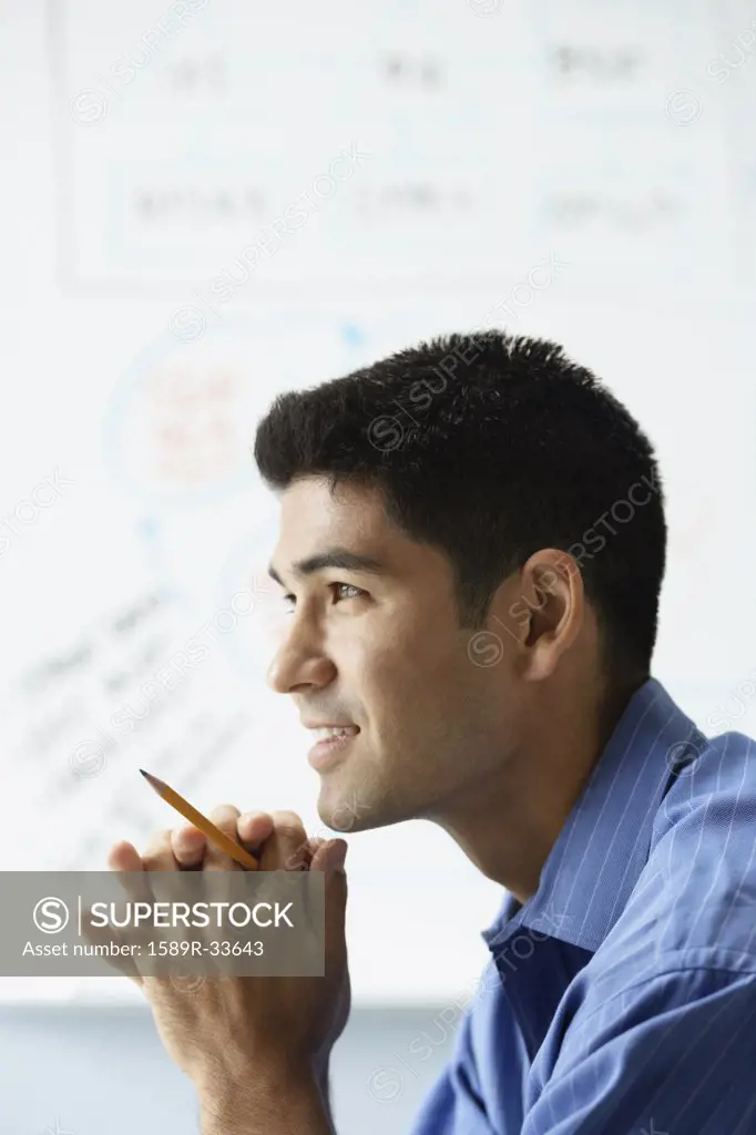 Profile of Asian businessman in front of whiteboard