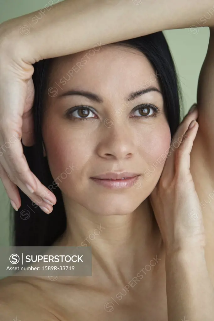 Asian woman with hands framing face