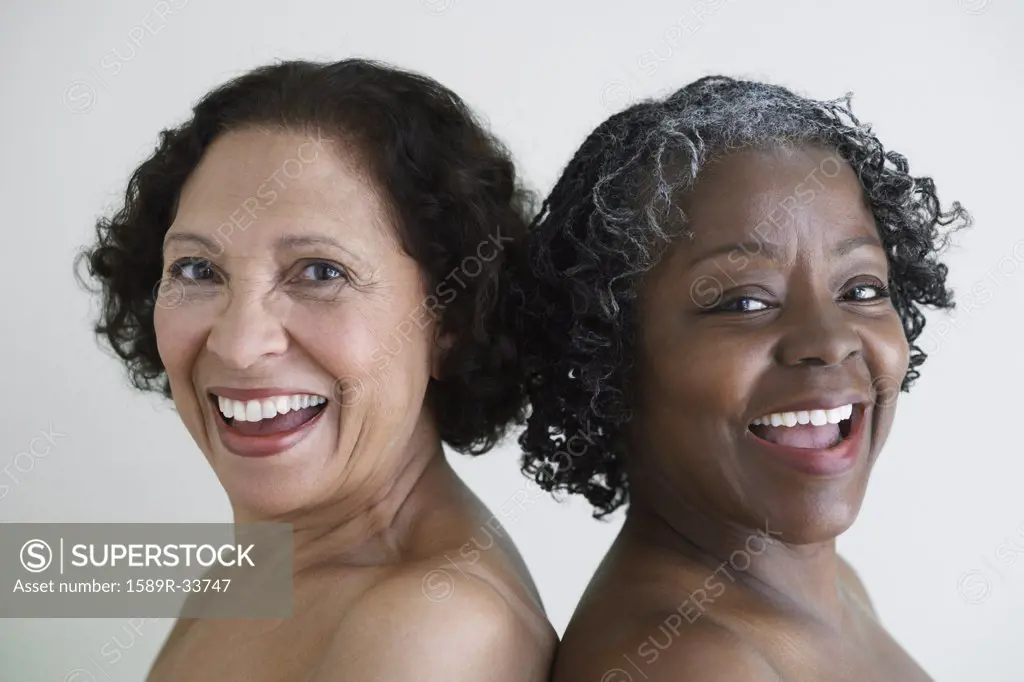 Two senior African women with bare shoulders