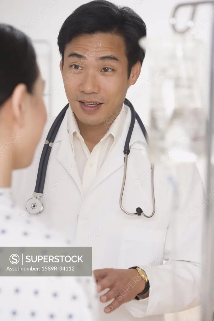 Asian male doctor talking to patient
