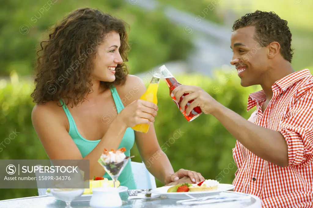 Couple toasting at outdoor restaurant