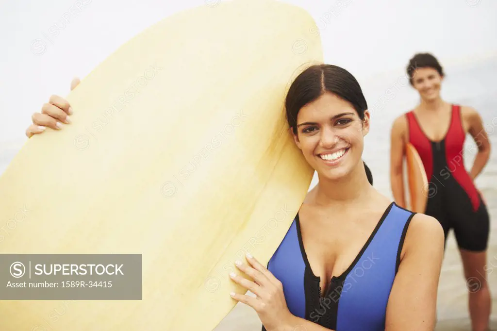 Young woman holding boogie board