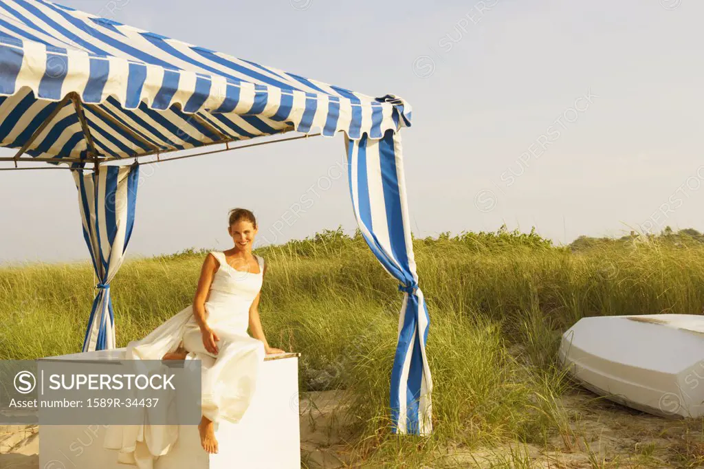 Bride under tent at beach