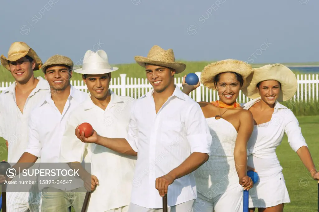 Multi-ethnic friends playing croquet