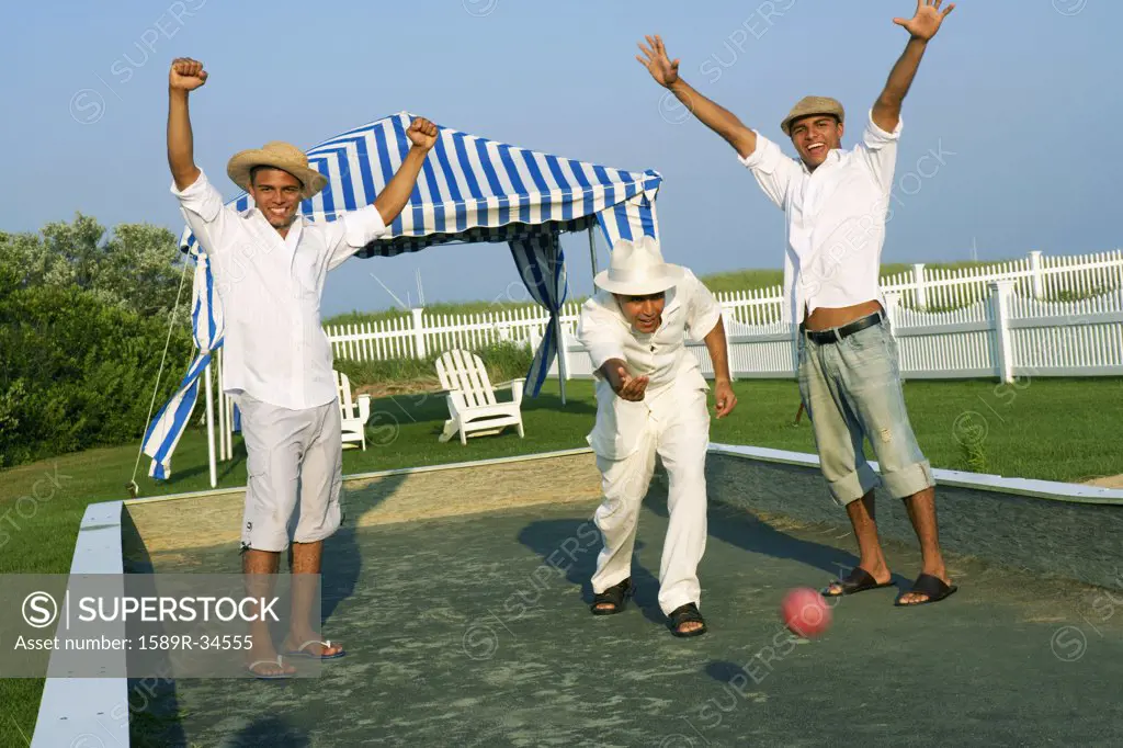 Young men cheering and playing game