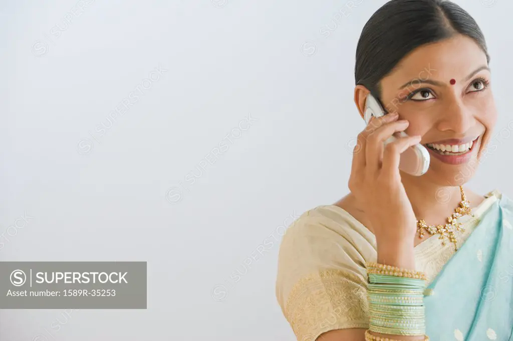 Indian woman in traditional clothing talking on cell phone
