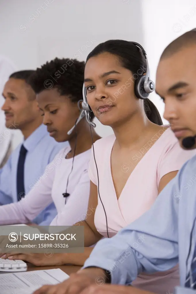 Multi-ethnic businesspeople wearing headsets