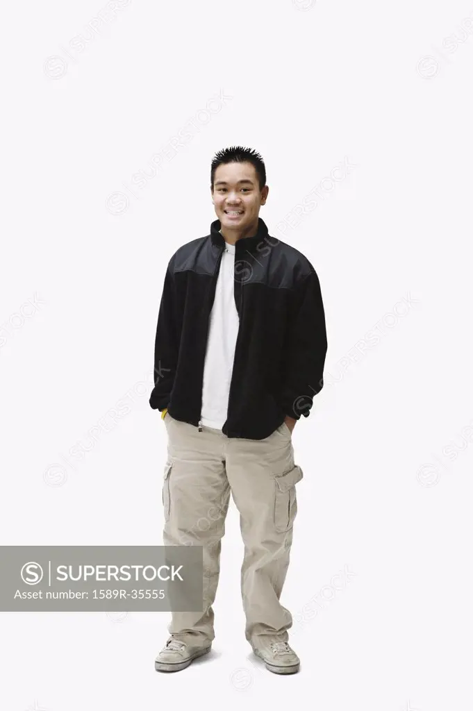Portrait of Asian man with hands in pockets