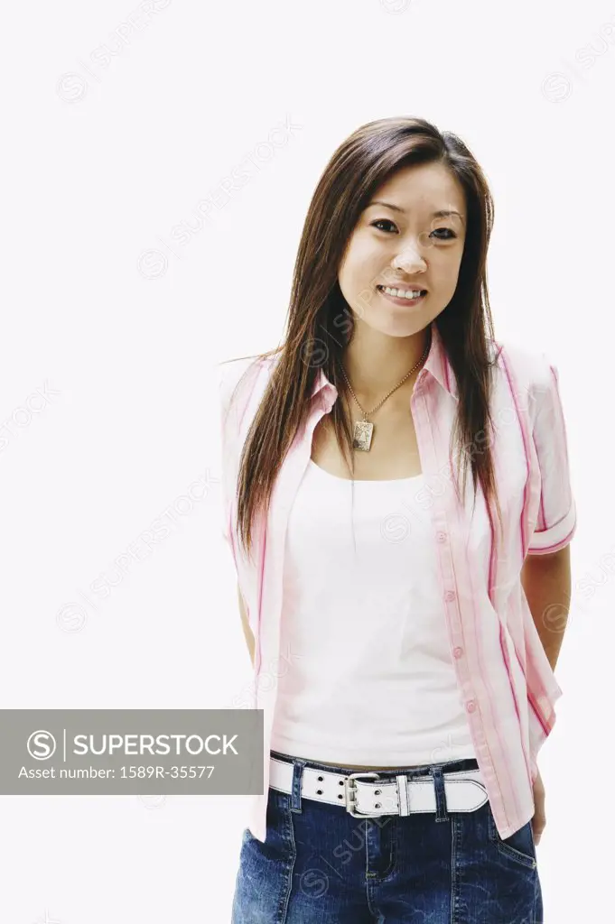 Portrait of Asian woman with hands behind back
