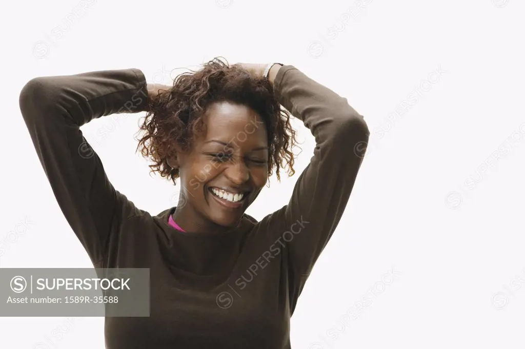 Portrait of African woman with hands in hair